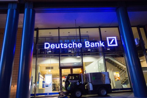 Bloomberg: A road cleaning machine drives past the exterior of a Deutsche Bank AG bank branch in Berlin, Germany, on Wednesday, Sept. 28, 2016. Deutsche Bank AG rose in Frankfurt trading after the German lender agreed to sell its U.K. insurance business for 935 mill