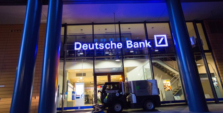 Bloomberg: A road cleaning machine drives past the exterior of a Deutsche Bank AG bank branch in Berlin, Germany, on Wednesday, Sept. 28, 2016. Deutsche Bank AG rose in Frankfurt trading after the German lender agreed to sell its U.K. insurance business for 935 mill